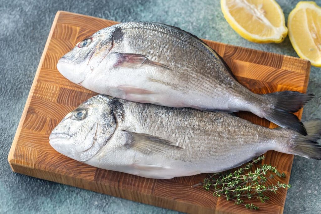 Fresh dorada on the wooden board By Alex9500